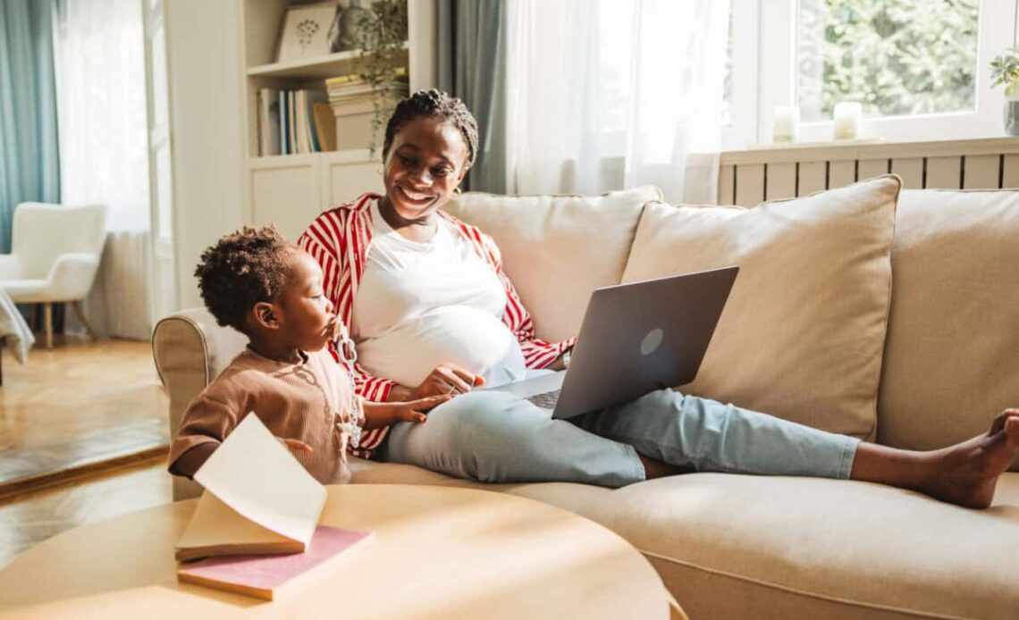 pregnant mother juggles work and childcare
