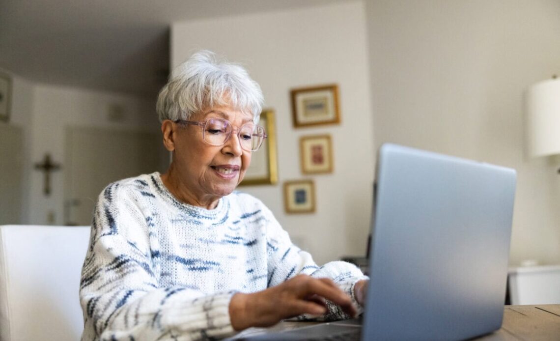 Senior uses a laptop computer
