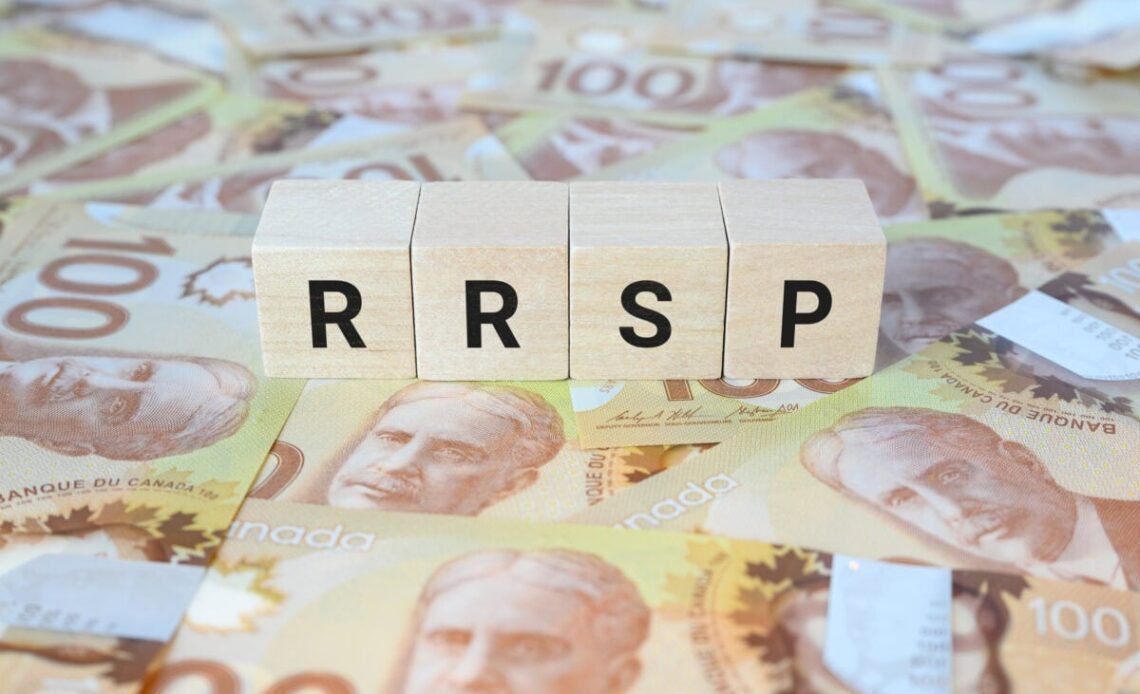RRSP (Registered Retirement Savings Plan) on wooden blocks and Canadian one hundred dollar bills.
